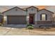 Charming single-story home with a two-car garage and a well-maintained desert landscape at 38145 W Amalfi Ave, Maricopa, AZ 85138