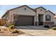 Charming single-story home with a two-car garage and a well-maintained desert landscape at 38145 W Amalfi Ave, Maricopa, AZ 85138