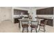 Spacious kitchen featuring granite countertops, a large island with seating, and stainless steel appliances at 38145 W Amalfi Ave, Maricopa, AZ 85138