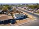 Aerial perspective of the home, street, and surrounding neighborhood with mountain views at 3833 W Fillmore St, Phoenix, AZ 85009