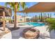 An inviting backyard featuring a sparkling pool, fire pit, and lush landscaping for outdoor enjoyment at 4037 S Taylor Dr, Tempe, AZ 85282