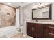 A full bathroom featuring a shower-tub combo, granite countertops, and a dark wood vanity at 4037 S Taylor Dr, Tempe, AZ 85282