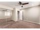 Neutral bedroom with mirrored closet doors and a ceiling fan at 4037 S Taylor Dr, Tempe, AZ 85282