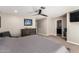 Comfortable bedroom with neutral tones, fan, and an ensuite bathroom entrance at 4037 S Taylor Dr, Tempe, AZ 85282