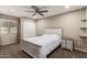 Cozy bedroom with a ceiling fan, white bedding, and matching nightstands at 4037 S Taylor Dr, Tempe, AZ 85282