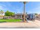 Charming single-story home featuring a well-manicured lawn, mature trees, and a private driveway with trailer at 4037 S Taylor Dr, Tempe, AZ 85282