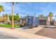 Charming single-story home featuring a well-manicured lawn, mature trees, and a private driveway with trailer at 4037 S Taylor Dr, Tempe, AZ 85282