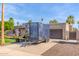 Charming single-story home featuring a well-manicured lawn, mature trees, and a private driveway with trailer at 4037 S Taylor Dr, Tempe, AZ 85282