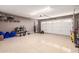 A spacious garage with epoxy floors, ample storage, and an automatic garage door at 4037 S Taylor Dr, Tempe, AZ 85282