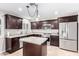 Beautiful kitchen featuring stainless steel appliances, granite countertops, dark wood cabinets, and center island at 4037 S Taylor Dr, Tempe, AZ 85282