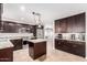 Beautiful kitchen with stainless steel appliances, granite counters, dark wood cabinets, and center island at 4037 S Taylor Dr, Tempe, AZ 85282