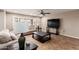 Cozy living room with neutral tones, tile floors, large windows, and a ceiling fan at 4037 S Taylor Dr, Tempe, AZ 85282