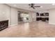 Open concept living room and kitchen with fireplace, tile flooring, and sliding glass door access to the backyard at 4037 S Taylor Dr, Tempe, AZ 85282