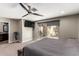 Main bedroom featuring carpet flooring, ceiling fan, TV and sliding glass doors to backyard with pool at 4037 S Taylor Dr, Tempe, AZ 85282