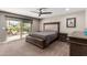 Main bedroom with carpet, ceiling fan, and sliding door leading to the backyard and pool at 4037 S Taylor Dr, Tempe, AZ 85282