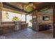 An inviting outdoor kitchen area with a grill, sink, and bar seating under a covered patio at 4037 S Taylor Dr, Tempe, AZ 85282