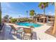 Backyard pool featuring beautiful palm trees, lounge chairs and a basketball hoop at 4037 S Taylor Dr, Tempe, AZ 85282
