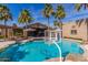 View of a backyard pool with basketball hoop and a covered patio featuring seating at 4037 S Taylor Dr, Tempe, AZ 85282