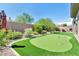 Spacious backyard featuring a putting green, desert landscaping, and a privacy wall for ultimate relaxation and entertainment at 40930 N Lambert Trl, Phoenix, AZ 85086