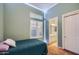 Inviting bedroom with accent lighting, a window, and a door leading to the bathroom at 40930 N Lambert Trl, Phoenix, AZ 85086