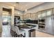Modern kitchen with stainless steel appliances, a breakfast bar, gray cabinets and granite counters at 40930 N Lambert Trl, Phoenix, AZ 85086
