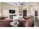 Inviting living room with hardwood floors, a cozy fireplace, and an open layout for entertaining or relaxation at 40930 N Lambert Trl, Phoenix, AZ 85086