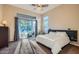 Bright main bedroom featuring sliding glass doors to an outdoor patio and a modern ceiling fan at 40930 N Lambert Trl, Phoenix, AZ 85086