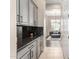 Pantry area boasts granite countertops, sleek cabinetry, and access to a naturally-lit living space for added convenience at 40930 N Lambert Trl, Phoenix, AZ 85086