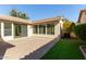 Paver patio with artificial grass and desert landscaping and sliding glass door access to home at 4428 E Wildhorse Dr, Gilbert, AZ 85297