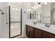 Well-lit bathroom includes a double sink vanity and walk-in shower at 4428 E Wildhorse Dr, Gilbert, AZ 85297