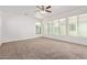 Versatile bonus room featuring neutral carpet, ceiling fan, and lots of natural light from three windows at 4428 E Wildhorse Dr, Gilbert, AZ 85297