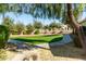 Well-maintained community green space with walking paths, lush lawns, and mature trees at 4428 E Wildhorse Dr, Gilbert, AZ 85297