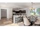 Eat-in kitchen with a dining area featuring a stylish chandelier and a dark wood kitchen with breakfast bar at 4428 E Wildhorse Dr, Gilbert, AZ 85297