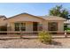 Charming single-story home featuring desert landscaping and inviting front porch with decorative wreath at 4428 E Wildhorse Dr, Gilbert, AZ 85297