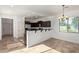 Bright eat-in kitchen featuring a breakfast bar, dark wood cabinets, tile flooring, and modern lighting at 4428 E Wildhorse Dr, Gilbert, AZ 85297