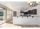 Bright kitchen with bar-style eating area, featuring stainless steel appliances and neutral tile floors at 4428 E Wildhorse Dr, Gilbert, AZ 85297