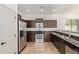Well-equipped kitchen featuring stainless steel appliances, granite countertops, and dark wood cabinetry at 4428 E Wildhorse Dr, Gilbert, AZ 85297