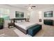 Bright main bedroom boasts a ceiling fan, two windows, and stylish ensuite access at 4428 E Wildhorse Dr, Gilbert, AZ 85297