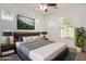 Beautiful main bedroom with large picture window, ceiling fan, and wall-mounted TV at 4428 E Wildhorse Dr, Gilbert, AZ 85297