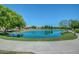 Picturesque community pond with mature landscaping and a walking path at 4428 E Wildhorse Dr, Gilbert, AZ 85297