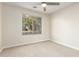 Cozy bedroom featuring neutral walls, carpet flooring, and a bright window view at 445 W Gary Ave, Gilbert, AZ 85233