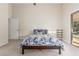 Bedroom with a ceiling fan, carpet flooring, access to the backyard, and a convenient closet at 445 W Gary Ave, Gilbert, AZ 85233