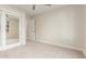 Comfortable carpeted bedroom with ceiling fan and mirrored closet doors at 445 W Gary Ave, Gilbert, AZ 85233