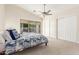 Serene bedroom with neutral tones, a ceiling fan, closet, and sliding glass doors to the backyard at 445 W Gary Ave, Gilbert, AZ 85233