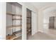Open closet shelving system with sliding closet door entrance at 445 W Gary Ave, Gilbert, AZ 85233