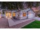 Home featuring manicured lawn, desert landscaping, and covered porch at 445 W Gary Ave, Gilbert, AZ 85233