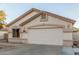 Charming tan home featuring a two-car garage and neutral trim at 445 W Gary Ave, Gilbert, AZ 85233