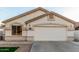 Home featuring a two-car garage, manicured lawn, and desert landscaping at 445 W Gary Ave, Gilbert, AZ 85233