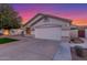 Home featuring a two-car garage, manicured lawn, and desert landscaping at 445 W Gary Ave, Gilbert, AZ 85233