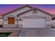 Home featuring a two-car garage, manicured lawn, and desert landscaping at 445 W Gary Ave, Gilbert, AZ 85233